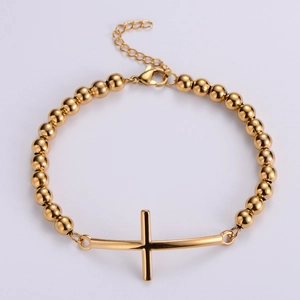 Close-up of gold-plated stainless steel bead bracelet with curved cross charm detail