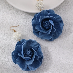 Detail of blue denim camellia flower earrings with white micro pearl bead and gold hooks