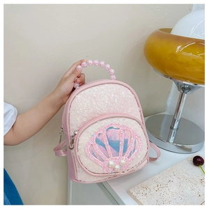 Detail of pink sequin girl's backpack with shell ornament and pearl handle