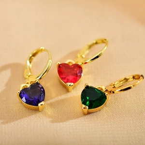 Close-up of heart-shaped zircon earrings in purple, red, and green on gold bases
