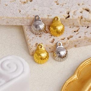 Macro detail of shell pendants in gold and silver finish with textured surface