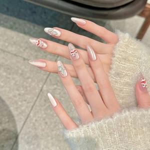 Detailed view of pink almond press-on nails with 3D lion dance and koi fish charms