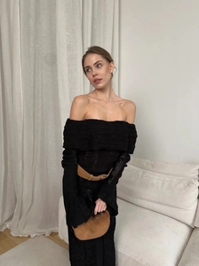 Detail of hollow-out knit texture on elegant black off-shoulder maxi dress with belt