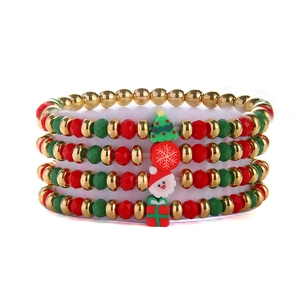 Close-up of a 5-piece Christmas beaded bracelet set with festive holiday charms