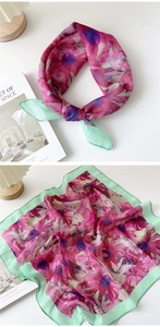 Detail of floral silk scarf with pink flowers, mint green border, and fine rolled edges