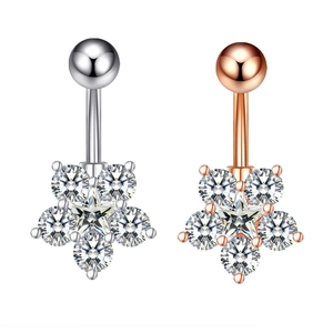 Detailed view of silver and rose gold belly rings with star shaped zircon inlays