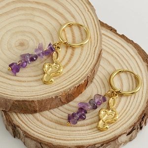 18k gold plated hoop earrings featuring amethyst stones and musical note charms on wood