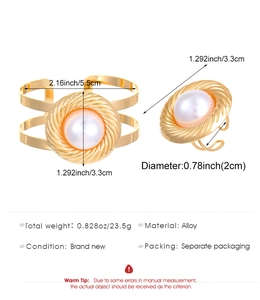 Detail of gold-colored alloy jewelry set featuring twisted texture and large pearls
