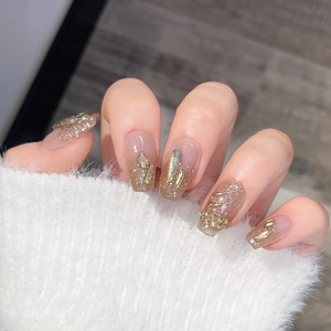 Luxurious champagne glitter press-on nails with 3D rhinestones and metallic accents