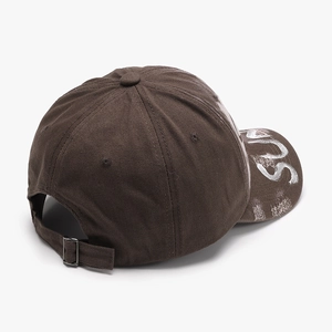 Brown cotton baseball cap with white graffiti SUP print on the brim and metal buckle