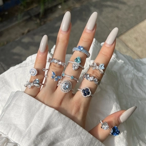 Close-up of elegant S925 silver ring featuring blue teardrop zircon and butterfly design