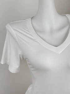 Detail view of the V-neckline and soft cotton texture on this white short sleeve T-shirt