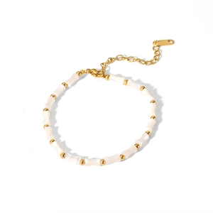 Detail of white shell beads and gold-plated bamboo joint links on vintage necklace