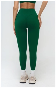 Detail of high-waisted dark green yoga pants showing push-up butt lift seam and slim fit