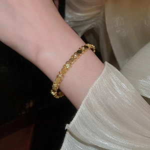 Detailed close-up of 18k gold plated iris flower bangle featuring sparkling zircon inlay