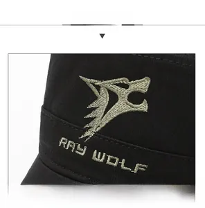 Macro detail of the olive green Ray Wolf embroidery on the black cotton flat top cap