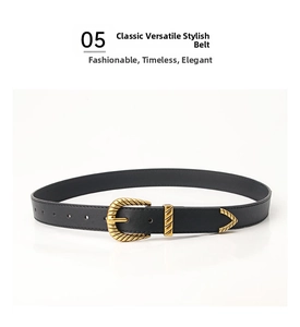 Detail of vintage black leather belt with gold engraved buckle and metal tip trim