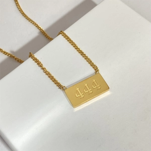 Detailed view of gold square pendant necklace engraved with lucky angel number 444