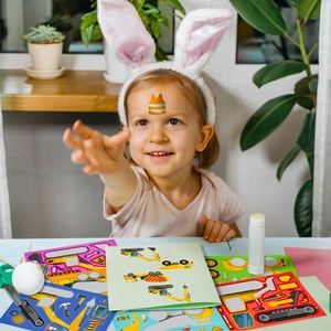 Girl playing with colorful engineering truck face-change stickers for DIY creative fun