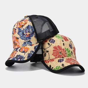 Straw textured trucker hats with vibrant floral prints and breathable black mesh for summer