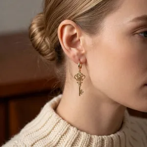 Vintage gold key-shaped drop earrings with zircon embellishments for a luxury look