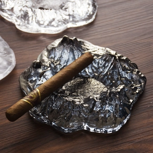 Glacier textured smoky glass cigar ashtray with Mount Fuji design on dark wood surface