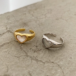 Close-up of heart-shaped adjustable shell rings in gold and silver finishes