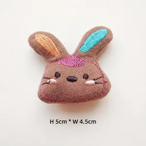 Detailed view of plush rabbit patch with brown fabric and colorful embroidery 5cm tall