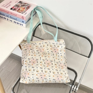 Detailed quilted texture of a white canvas tote bag with cute puppy and bow patterns