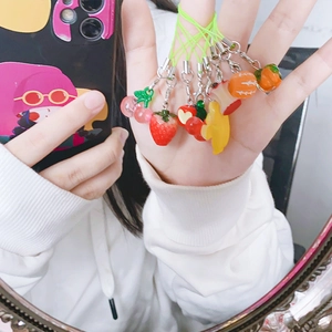 Detailed view of various fruit-shaped charms including strawberry and banana models