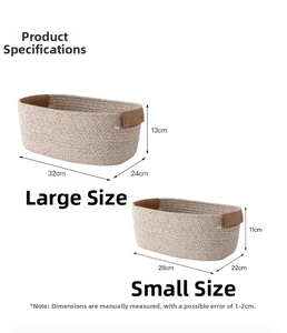 Detail view of woven cotton rope storage baskets with brown leather handles in two sizes