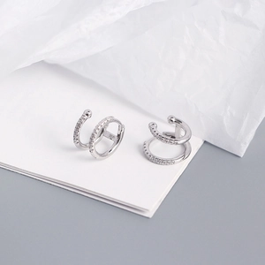 Detailed macro view of silver double-hoop earrings featuring micro-pave cubic zirconia
