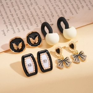 Eight-piece vintage gold butterfly and geometric heart earring set with pearl details