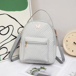 Light gray quilted mini backpack with butterfly logo and woven straps for women