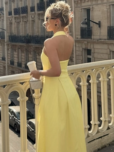 Elegante abito a ruota giallo con scollo all'americana e schiena scoperta da donna