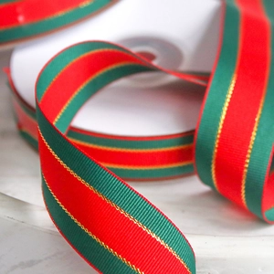 Macro detail of Christmas grosgrain ribbon with red green stripes and gold metallic edges