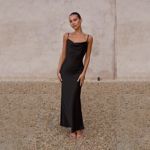 Detail of elegant black satin slip dress with deep V-neckline and slim fit silhouette