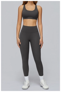Detail of high-waist charcoal grey yoga leggings and sports bra with premium matte finish