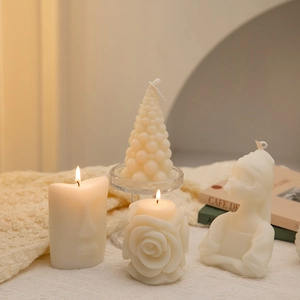 Artistic detail of portrait and geometric scented candles in cream white for home decor