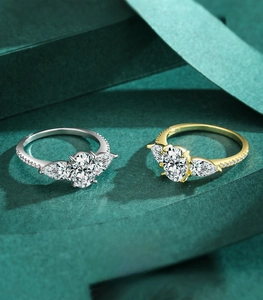 Detail of 925 silver three-stone rings with oval cut and teardrop side stones