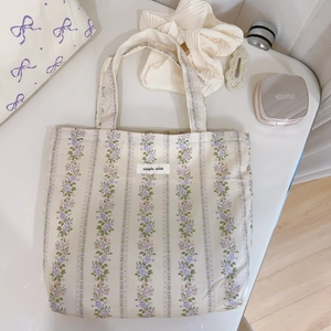 Close-up of floral canvas tote bag featuring simple wish label and purple flower pattern