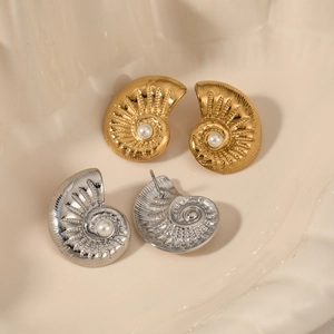 Golden and silver spiral conch earrings with shell texture and central pearl accent