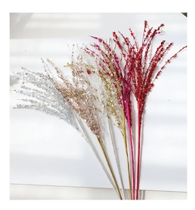 Close-up of glittery firework branches in multiple colors for festive floral decoration