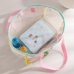 Detail view of colorful mesh beach tote bag showing spacious interior and woven handles