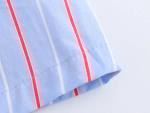 Close-up of blue and white striped cotton shirt showing premium stitching and fabric texture