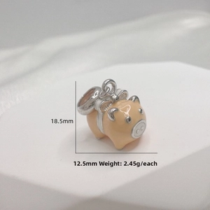 Detail of S925 silver pig pendant with orange enamel and silver bow accents