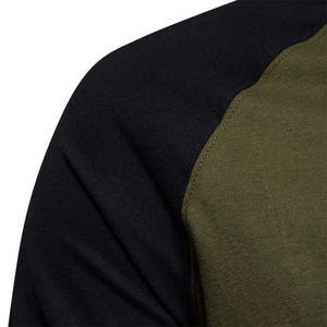 Close-up of raglan sleeve stitching on a men's black and olive green拼接 t-shirt