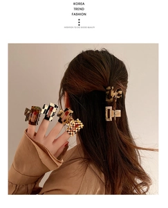 Detail view of acetate checkered and leopard hair claws with strong metal springs
