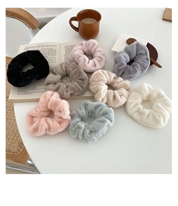 Detail showing eight colors of soft faux rabbit fur scrunchies in a lifestyle setting