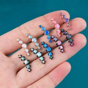 Macro shot of 8 colors of opal cartilage studs with four-stone linear design and metallic finish